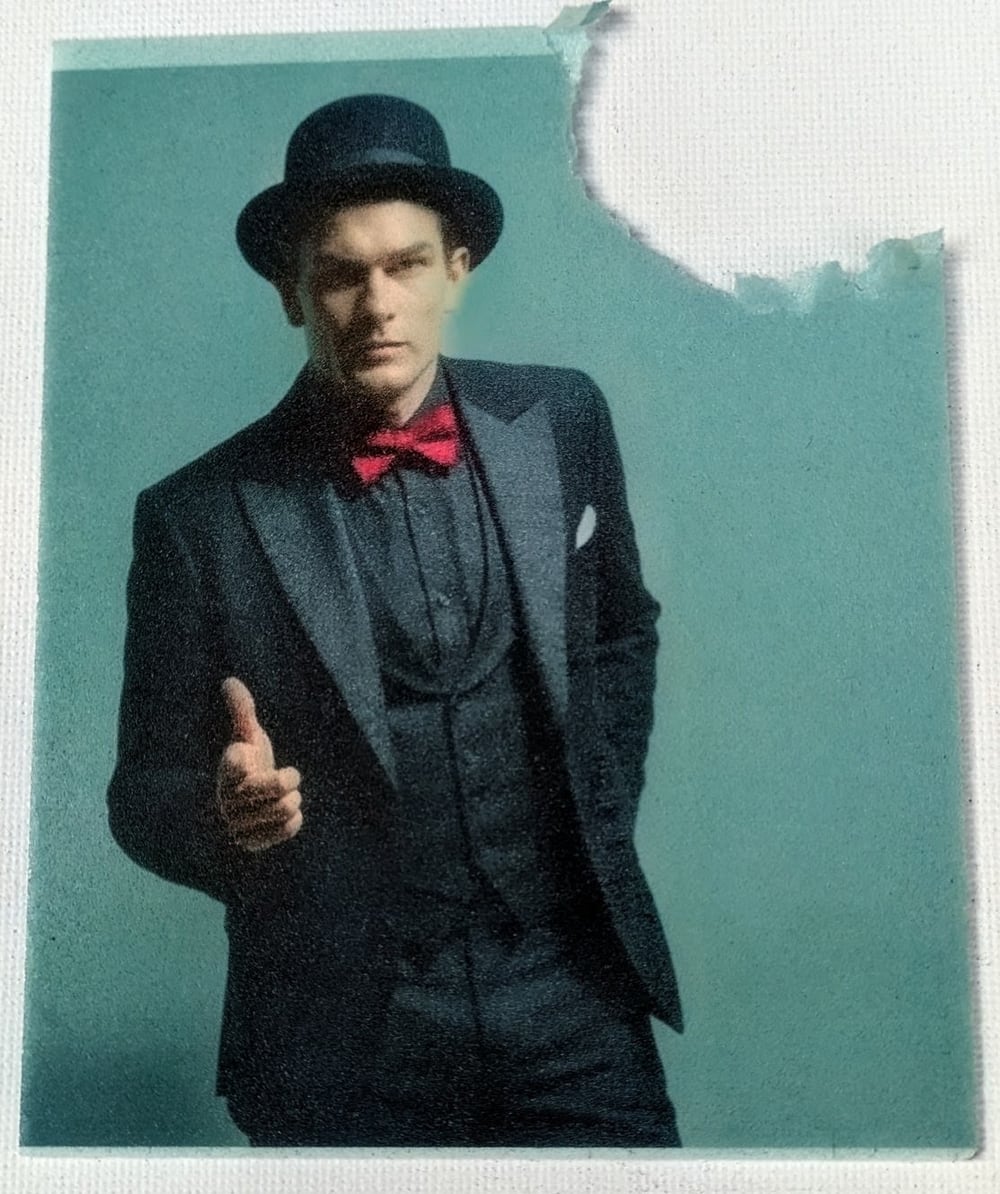 Portrait of a guest in a suit and bowler hat printed on edible paper, bitten at one corner