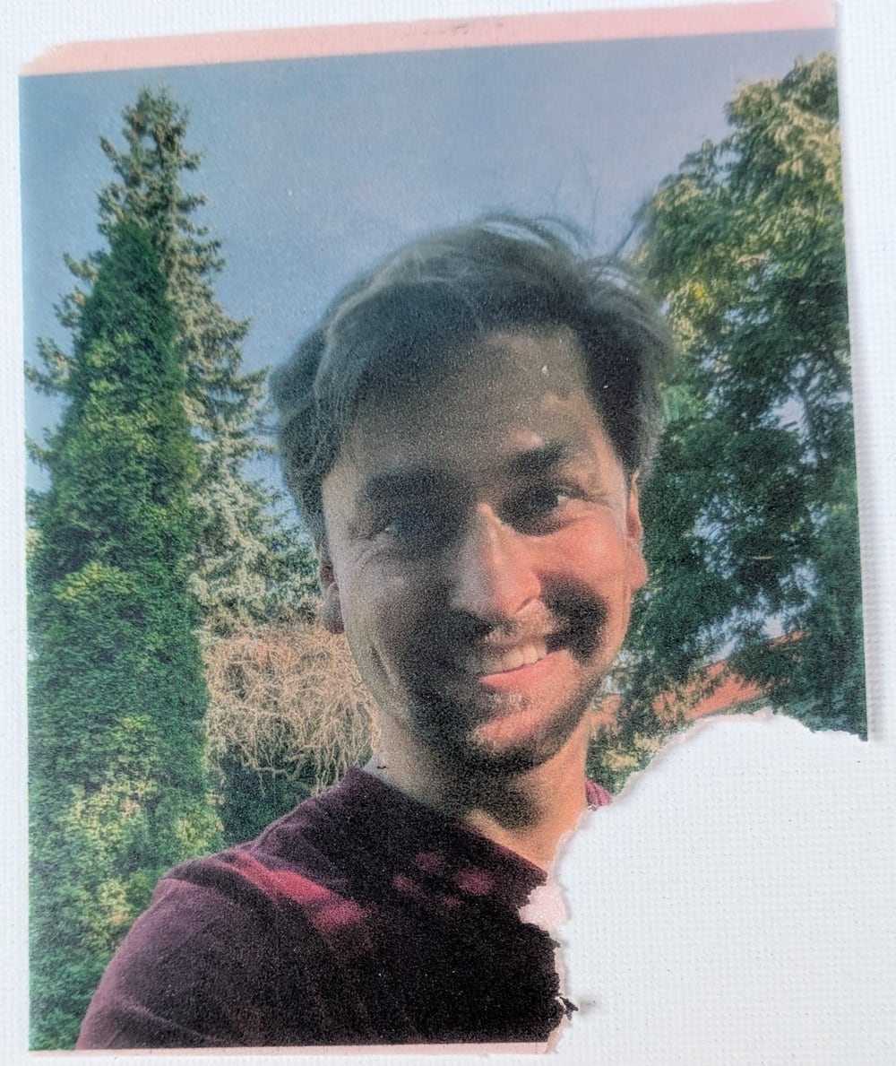 Portrait of a smiling guest outdoors printed on edible paper, bitten at one corner